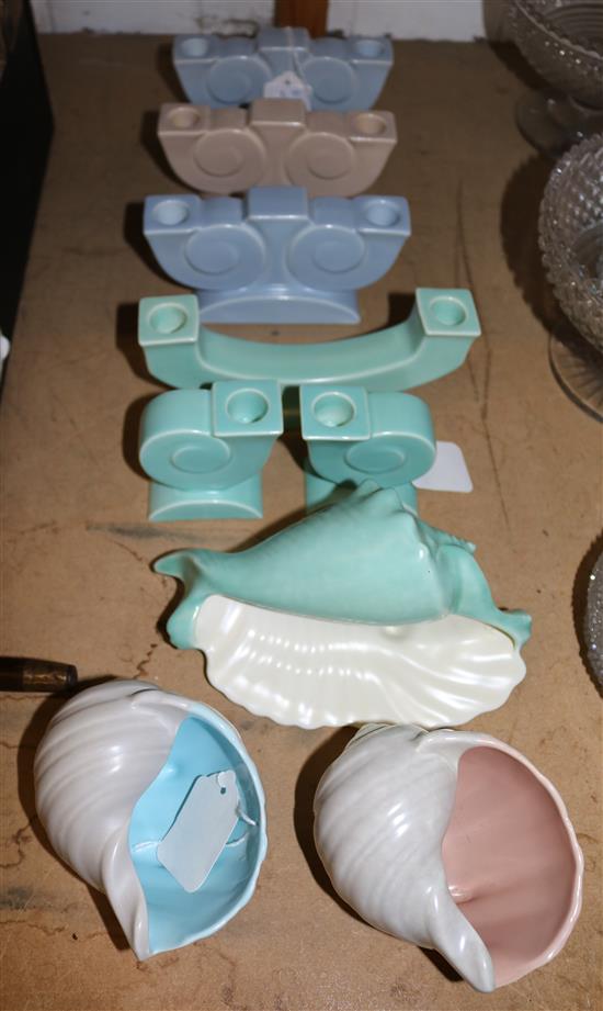 Four Poole Pottery candelabra, two pairs of candlesticks and three shell vases, variously glazed